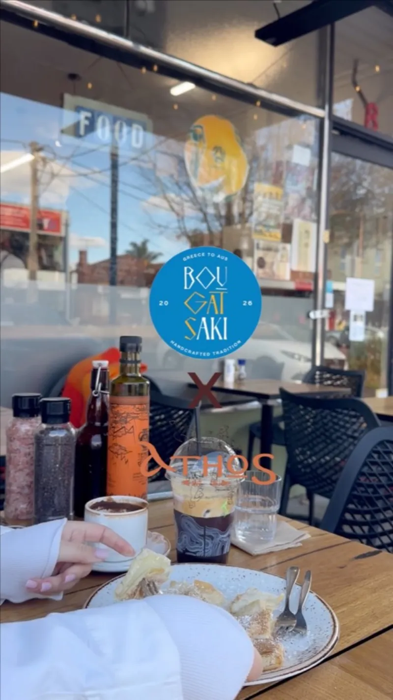 Greek coffee, an iced coffee and bougatsa on a cafe table at Bougatsaki