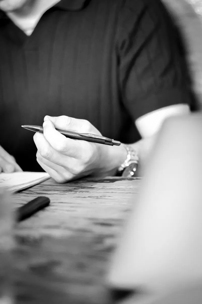 Close-up of a hand writing out a campaign plan